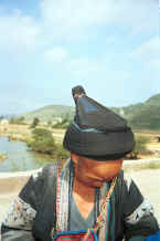 Jpeg 37K Old Bouyei textile seller getting ready to model the jacket which I had just bought and making sure she is properly dressed for a photo - Shitou village, Huanggousu township, Zhen Nin county, Guizhou province - 0010u08.jpg