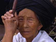 to Jpeg 53K Old woman watching a festival in Songtao Miao Autonomous County, Tongren Prefecture, Eastern Guizhou Province, 8 Augus, 2003.