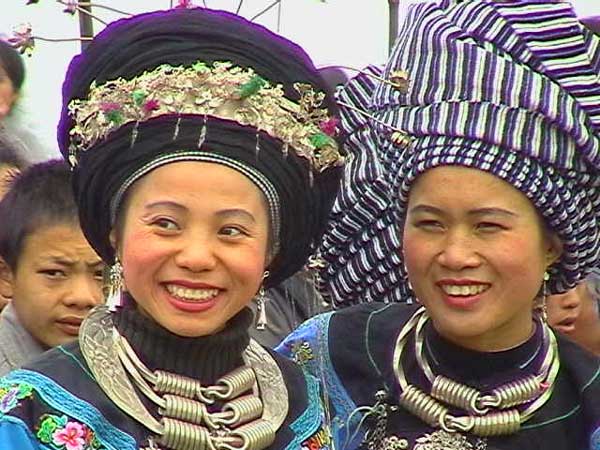 57K Jpeg Miao girls in woven turbans and heavy silver jewlry at a festival in a village in Songtao Miao Autonomous County, Tongren Prefecture, eastern Guizhou Province.