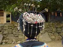 to Jpeg 47K Back view of the silver decorations on the headdress of a Miao girl at a festival in a village in Songtao Miao Autonomous County, Tongren Prefecture, eastern Guizhou Province. 