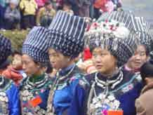 to Jpeg 45K A group of Miao girls in their festival finery including the striking woven turbans 6 -10 metres in length in a village in Songtao Miao Autonomous County, Tongren Prefecture, eastern Guizhou Province.