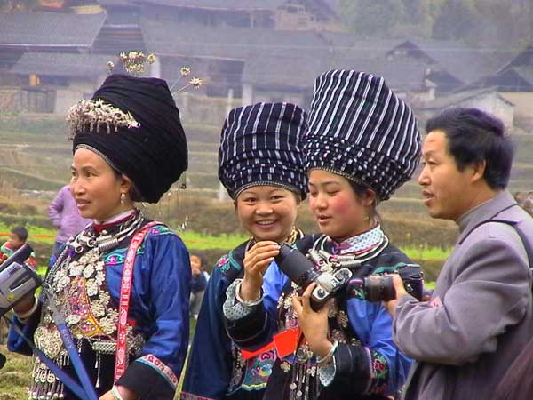 Jpeg 46K Miao women dressed in their festival finery and examining cameras a village in Songtao Miao Autonomous County, Tongren Prefecture, eastern Guizhou Province.