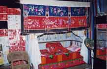 to Jpeg 63K Display of embroidery on a bed possibly for a wedding in Songtao Miao Autonomous County, Tongren Prefecture, eastern Guizhou Province.