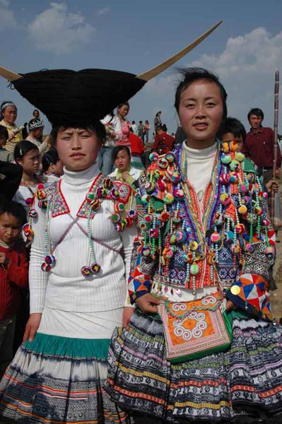 Jpeg 67K White Miao girls in festival dress at the White Miao Dance Flower festival near Dafang in April 2007