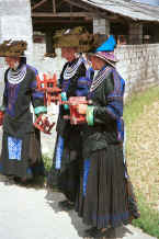 Jpeg 33K Young Black Miao girls dressed in their festival finery welcoming us by clapping small stools together. Zuo Qi village, Min Gu township, Zhenfeng county, Guizhou province 0010p16.jpg