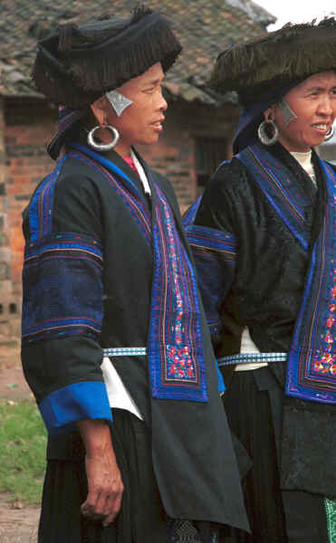 Two middle aged Black Miao women showing their pierced ears and heavy ear rings (which the young girls now wear on braid to avoid the large holes in distorted ear lobes) - Zuo Qi village, Min Gu township, Zhenfeng county, Guizhou province 0010p24.jpg