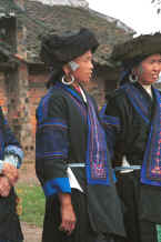 Jpeg 26K Two middle aged Black Miao women showing their pierced ears and heavy ear rings (which the young girls now wear on braid to avoid the large holes in distorted ear lobes) - Zuo Qi village, Min Gu township, Zhenfeng county, Guizhou province 0010p24.jpg