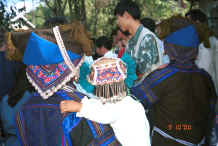 Jpeg 53K Back view of mother and child showing their embroidered headdresses and the beautifully embroidered back panel of the mother's jack - Zuo Qi village, Min Gu township, Zhenfeng county, Guizhou province 0010q26.jpg