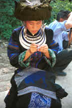 Jpeg 36K Black Miao girl in her festival finery demonstrating her embroidery on a baby carrier piece - Zuo Qi village, Min Gu township, Zhenfeng county, Guizhou province 0010q34.jpg