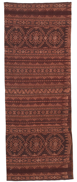 Sarong from the weaving group at Sikka and the design is typical from that area. Commercial thread and synthetic dyes. The large motif is a flower basket (so I was told), like the flower offering baskets you see outside homes in Bali.