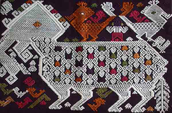 Jpeg 71K A new (end 20th beginning 21st century) woven fragment of a siho, a mythological animal half-lion, half-elephant unique to the Lao culture and considered to be imbued with special powers shown with an ancestor figure riding on his back between two birds.