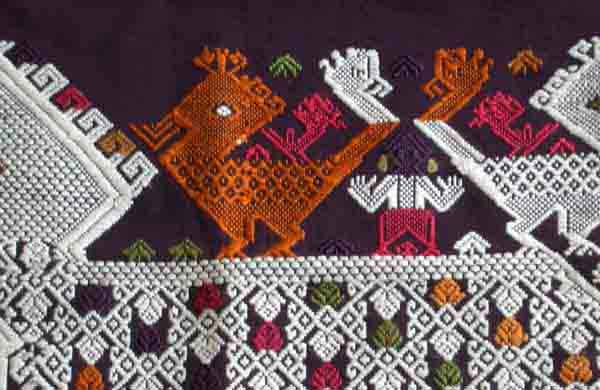 Jpeg 52K A new (end 20th beginning 21st century) woven fragment showing an ancestor figure between two bird riding on the back of a siho, a mythological animal half-lion, half-elephant unique to the Lao culture and considered to be imbued with special powers.