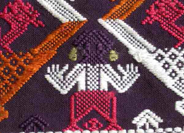 Jpeg 51K A new (end 20th beginning 21st century) woven fragment showing an ancestor figure. Woven in cotton, probably chemical dyed supplementary weft coloured threads. 