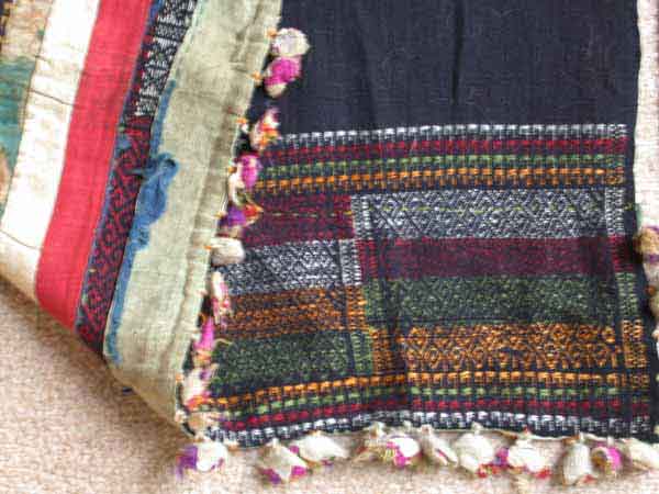 Jpeg 61K Strips of silk applied covering a woven pattern at the end of an indigo dyed cotton woven length of a pha biang