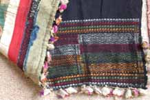 to Jpeg 61K Strips of silk applied covering a woven pattern at the end of an indigo dyed cotton woven length of a pha biang