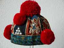 to Jpeg 58K  Yao boy's hat bought in a village near Chiang Rai. The hat is not new and looks to have some hand-woven indigo cloth incorporated into it. 3476