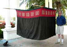 to Jpeg 43K Lao-Tai (possibly Black Thai (Tai Dam) style) complete mosquito net illustrating how it would be hung over bamboo poles. The top is plain white cotton cloth, possibly hand woven and spun, not netting. Note the size against a 6' man.