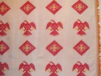 to 61K jpg 02 - Detail 2 of Itneg cotton decorative cloth with Spanish diamond eagle design, Northern Luzon, early 20th century. This piece was made from hand-spun, hand-woven cotton and is signed with the weaver's embroidery. 154 cm x 220 cm without fringe
