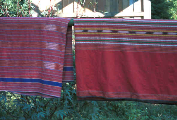 Two hand woven sarongs of mainly koh (red) dyed cotton with additional ikat dyed and plain dyed stripes 8812o34.jpg