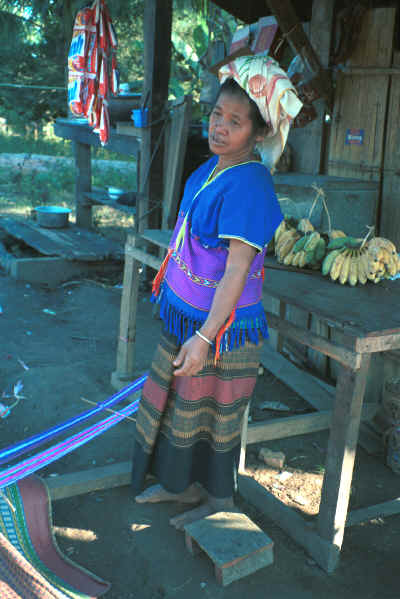 Sgaw Karen woman standing by her backstrap loom dressed in a traditional hand-woven blouse 8812o37.jpg