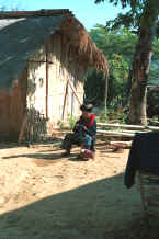 to Jpeg 35K A Yao woman sitting in the sunshine outside a house working on her embroidery in a village in the hills around Chiang Rai 8812q08.jpg