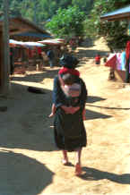 to Jpeg 26K A grandmother carrying her grandchild in a baby carrier on her back in a village in the hills around Chiang Rai 8812q28.jpg