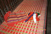 to Jpeg 34K A woven bag and some cotton and silks for the supplementary weft as shown in the weaving.  They had been dyed by the Black Thai weaver from dyes (probably chemical) bought locally.  Note the edges of the seat cushion made from a similar length of weaving.  Dien Bien Phu, Lai Chau Province 9510D01.JPG