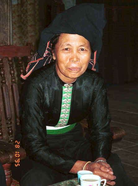 Jpeg 23K Black Thai woman in her home in a village near Dien Bien Phu.  she wove and died the material for her head cloth from locally grown indigo.  She is the wife of the local Party Secretary. 9510D08.JPG