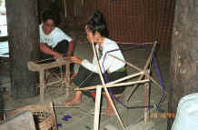 to Jpeg 36K Black Thai lady winding dyed thread - probably silk - onto a bobbin before weaving.  Village near Dien Bien Phu, Lai Chao Province 9510E14.JPG