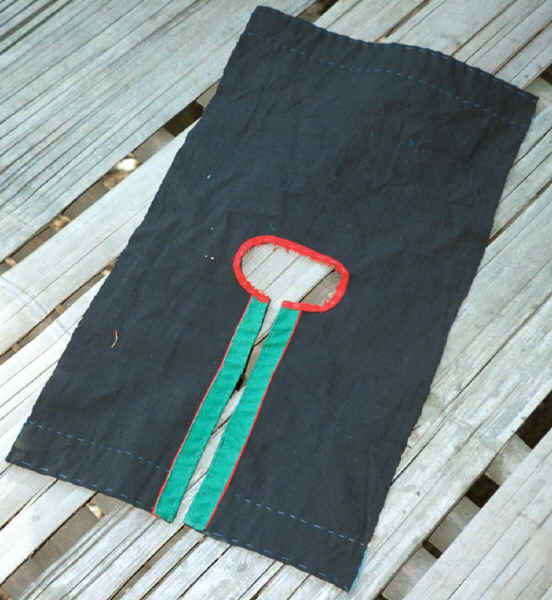 Jpeg 34K The front and back bodice piece of (probably an older) woman's blouse.  This is being made from indigo dyed cotton which is likely to have been dyed at home - as indicated by such cloth hanging up to dry outside the house.  Black Thai village, Dien Bien Phu, Lai Chao Province. 9510E23.JPG
