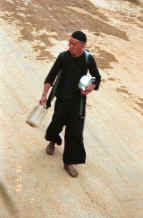 to Jpeg 31K Black Hmong man striding through the streets of Sa Pa, Lao Cai Province 9510I10.JPG