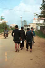 to Jpeg 30K Black Hmong young men walking home from Sa Pa, Lao Cai Province.  Note the various styles to wear the trousers! 9510I22.JPG