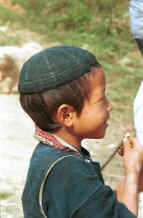 Jpeg 46K Young Black Hmong boy near a school in the hills of Sa Pa, Lao Cai Province - note the embroidered collar on his jacket.  In common with many Hmong groups in Vietnam and Thailand the embroidery is on the underside of the collar. 9510I37.JPG