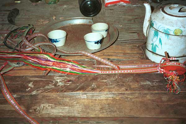 Jpeg 41K 9511A01 Woven braids, probably Dao Quan Trang but possibly Nung, woven on a toe-waist tension loom. These briads were used as a harness to carry a machete or knife. Similar braids used to tie around the waist of Dao Quan Trang women's coats. Luong village, Lao Cai province in 1995 shortly after leaving Sa Pa for the town of Lao Cai.
