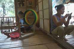 to Jpeg 32K mc2 Kha Thi Thu spools factory-produced thread for use in weaving, while her sister-in-law embroiders a purse to sell to tourists. The Mai Chau valley, Hoa Binh Province, northern Viet Nam.