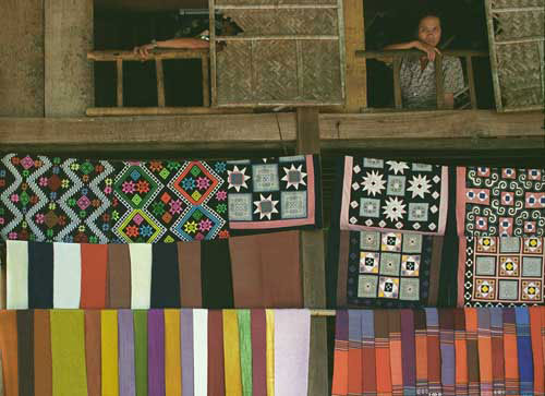 Jpeg 45K mc3 Textiles on display for sale, on the bottom left, factory-made scarves and on the top left and bottom right, hand-made Thai fabrics using factory-made thread. Top right are Hmong pillowcases. The Mai Chau valley, Hoa Binh Province, northern Viet Nam.