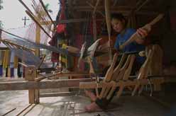 to Jpeg 31K mc4 Thu weaves fabric on the loom beneath her house which she shares with all the women in her family. The Mai Chau valley, Hoa Binh Province, northern Viet Nam.