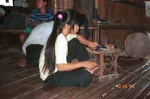 to Jpeg 41K Girl winding bobbins for weaving in Ban Lac village, Mai Chau District in Hoa Binh Province near the border with the north-western part of Thanh Hoa Province in north west Vietnam. 9510A10T