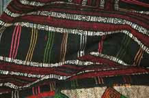 to Jpeg 88K Detail of Southern White Thai skirt purchased in Ban Lac village in the Mai Chau district, Hoa Binh (Ha Son Binh) Province, Vietnam.  Supplementary weft, embroidered thin vertical stripes, embroidered hem.9511A35T